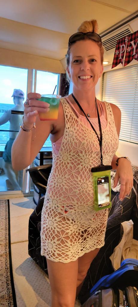 lady smiling with drink on yacht